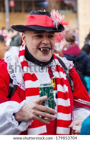 COLOGNE, GERMANY - MARCH 03: unidentified costumed man with face painting at the Rose Monday parade on March 03, 2014 in Cologne. The Rose Monday parade of Cologne is the largest in Germany.