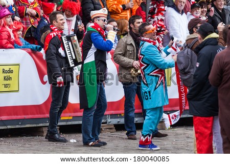 COLOGNE, GERMANY - MARCH 03: unidentified and costumed people with a crew from Radio Station Radio KÃ?Â¶ln at the Rose Monday parade on March 03, 2014 in Cologne. The parade is the largest one in Germany