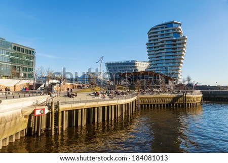 HAMBURG, GERMANY - MARCH 08: Marco Polo Tower with unidentified people on March 08, 2014 in Hamburg. The tower was designed by Behnisch architects and gained 2011 the architecture award concrete.