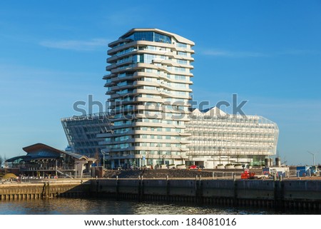 HAMBURG, GERMANY - MARCH 08: Marco Polo Tower with unidentified people on March 08, 2014 in Hamburg. The tower was designed by Behnisch architects and gained 2011 the architecture award concrete.