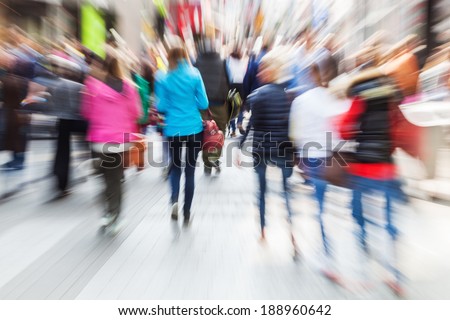 crowd of shopping people in the busy street of the city with creative zoom effect
