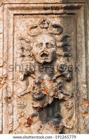 antique sculpture at a column in the old town of Verona, Italy