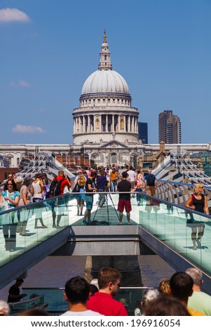 LONDON - MAY 18: view from the Millennium Bridge on St Pauls Cathedral with unidentified people on May 18, 2014 in London. St Pauls is a Church of England cathedral the seat of the Bishop of London