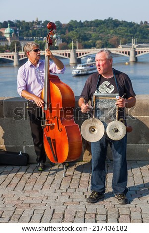 PRAGUE, CZECHIA - SEPTEMBER 04: unidentified street artists on the famous Charles Bridge on September 04, 2014 in Prague. The centre of Prague is protected by UNESCO and a famous travel destination
