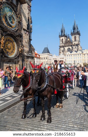 PRAGUE, CZECHIA - SEPTEMBER 05: wedding carriage with unidentified people on the Old Town Square on September 05, 2014 in Prague. Prague is the sixth-most-visited European city and famous for weddings