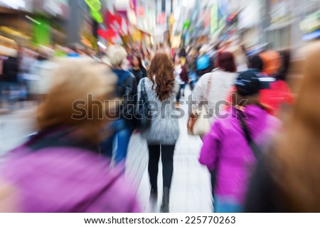 crowd of shopping people in the city with creative zoom effect, made by camera