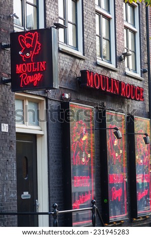 AMSTERDAM, NETHERLANDS - NOVEMBER 13: sex club Moulin Rouge in the red light district on November 13, 2014 in Amsterdam. The district is world reknown and a famous attraction for tourists.