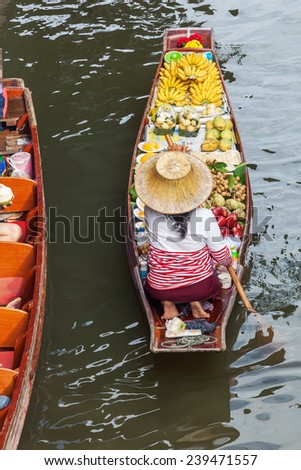 market woman with a boat on the famous floating market Damnoen Saduak in Bangkok, Thailand