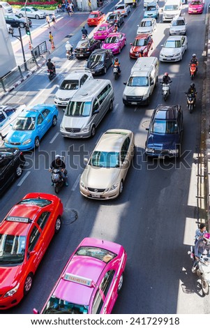 BANGKOK, THAILAND - DECEMBER 11, 2014: busy traffic on the Silom Road in Silom district with unidentified people. Bangkok is one of the most important economic and transport centres in South-East Asia