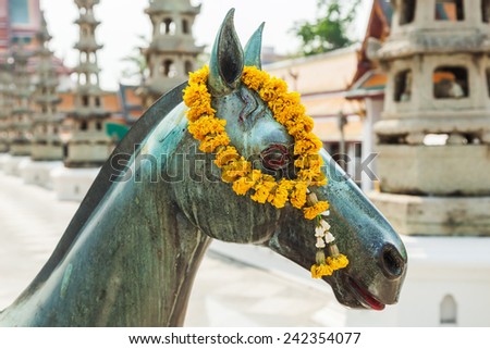BANGKOK, THAILAND - DECEMBER 12, 2014: horse sculpture at Wat Suthat, a royal temple of first grade, one of ten such temples in Bangkok -23 in Thailand-. Construction was begun by King Rama I in 1807