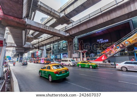BANGKOK, THAILAND - DECEMBER 11, 2014: street scene under skytrain in Silom district with unidentified people. Bangkok is one of the most important economic and transport centres in South-East Asia