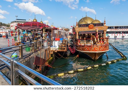 ISTANBUL, TURKEY - APRIL10,2015: fish restaurant boats at the banks of the Eminoenue district of Istanbul with unidentified people. Istanbul is the largest city in Turkey and famous travel destination