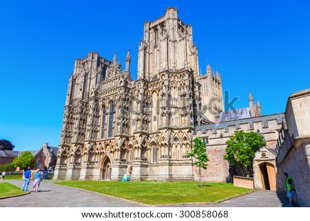WELLS, ENGLAND - JUNE 30, 2015: Wells Cathedral with unidentified people is a Church of England in Wells, Somerset, dedicated to St Andrew the Apostle, and is the seat of the Bishop of Bath and Wells