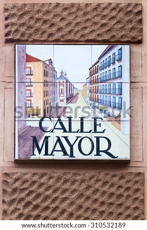 MADRID, SPAIN - MARCH 17, 2015: artistic street sign in Madrid. It's a uniqueness that the street signs in Madrid are made from tiles hand painted with different subjects by Spanish artists