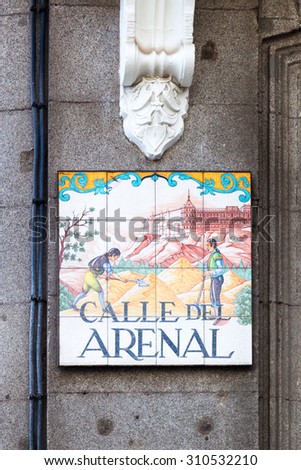 MADRID, SPAIN - MARCH 17, 2015: artistic street sign in Madrid. It\'s a uniqueness that the street signs in Madrid are made from tiles hand painted with different subjects by Spanish artists
