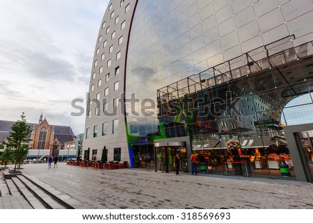 ROTTERDAM, NETHERLANDS - SEPTEMBER 03, 2015: modern market hall in Rotterdam at dawn. It was opened Oct 1, 2014 by Queen Maxima, designed by architect firm MVRDV. With unidentified people