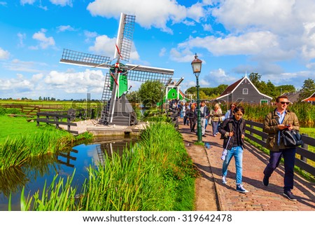 ZAANSE SCHANS, NETHERLANDS - SEPTEMBER 03, 2015: unidentified people at the museum village. A Collection of historic windmills and houses from the region were moved to the area starting 1961