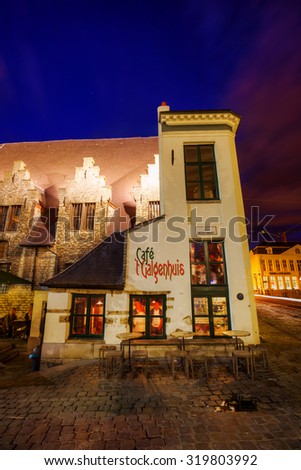 GHENT, BELGIUM - SEPTEMBER 02,2015: cafe in a historical building beside famous Butchers Hall at night. Its the smallest premise in Ghent. On the back were convicts hung on the gallows
