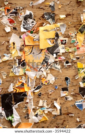 Abstract image of wall and pieces of torn posters