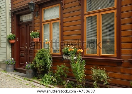 Traditional cozy wooden house in Bergen, Norway, with its beautiful little garden