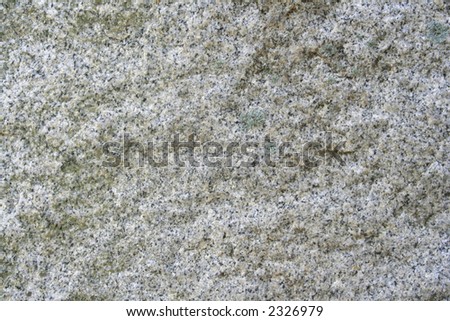 Granite with sunlight shining on it to show the shadows and texture of the natural stone. Reflective minerals in the stone shine in the sunlight.
