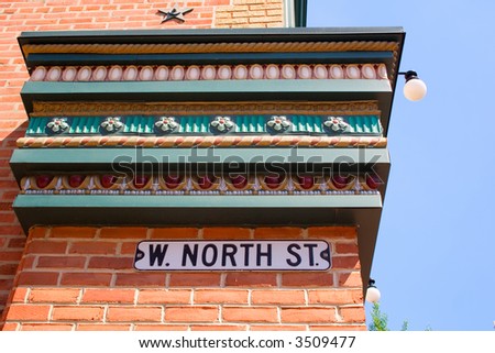 Street Sign on the Side of a Building with Ornate Trim