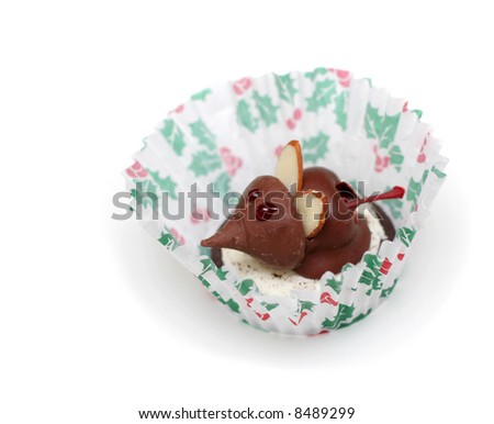 A Christmas mouse cookie made with a chocolate covered cherry, a chocolate candy kiss, and an almond slice ears.