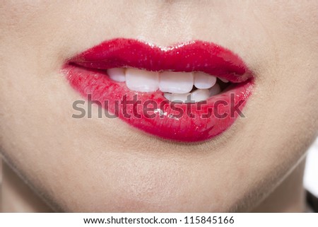 Close up image of woman biting her lips