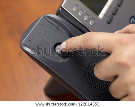 Close-up shot of a person disconnecting black land line phone.