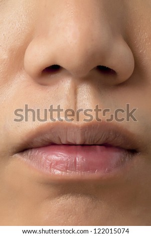 A close up image of a human face that camera focused on nose and lips