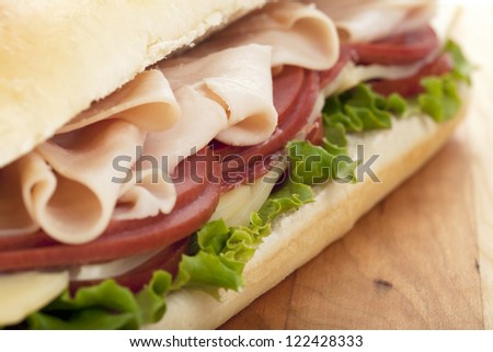 Close-up image of a bacon sandwich on a wooden table