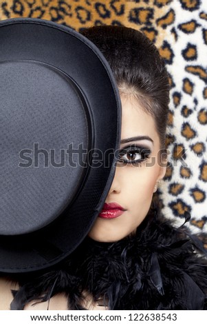 Close-up portrait of a gorgeous Indian fashion model posing with a hat