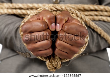 Close-up image of businessman\'s hand tied with rope