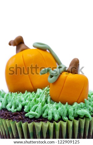 Detailed view of a Cupcake with pumpkin miniature displayed against white background.