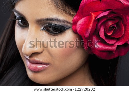 Detailed shot of  woman with a rose in her hair