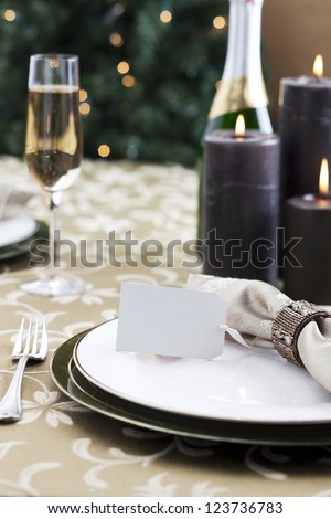 Formal Christmas dinner with light reflection of a Christmas tree