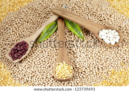 Close-up shot of variety of food grains and wooden spatula.