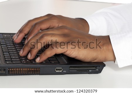 Business hands typing in laptop keyboard on a macro image