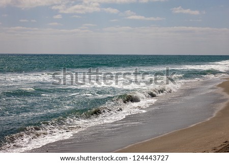 Waves roll up and down the beach in Palm Beach, Florida.