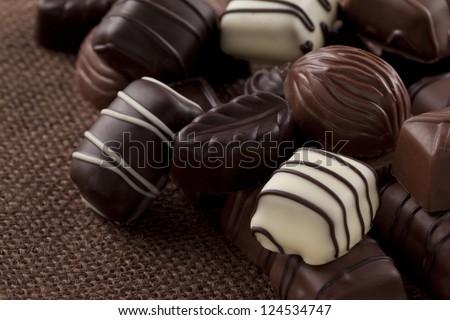 Close-up image of chocolate bar candies over the brown table