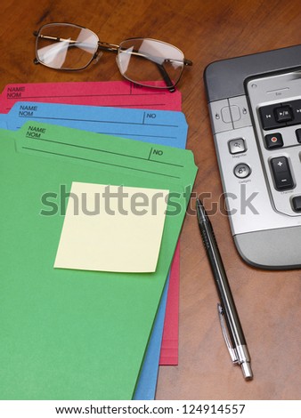 Close-up cropped shot of files with pen and keyboard on office desk.