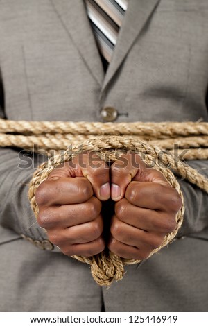 Business hands tied with rope stock photo