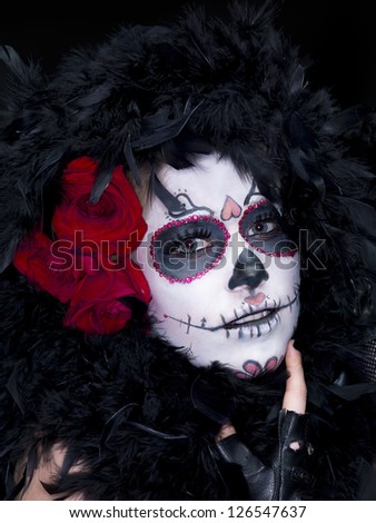 Close-up shot of a female wearing scary sugar skull make-up with fur and roses.