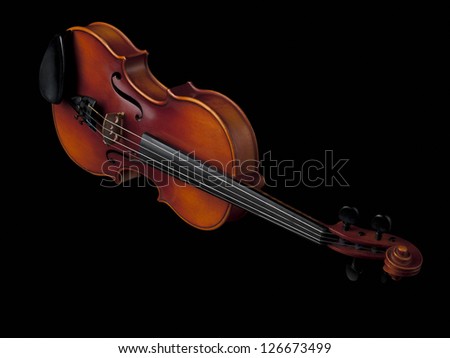 Image of a old wooden violin isolated over plain black background.