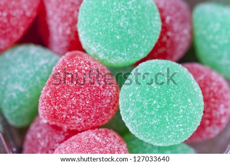 Extreme close-up shot of heap of red and green sugar candy.