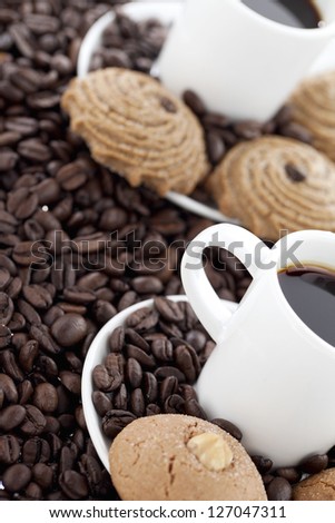 Black coffee and cookies with coffee beans