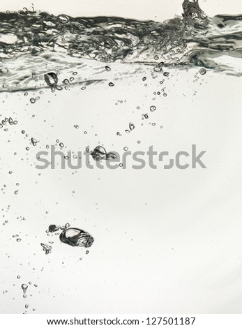 Close up image of underwater bubbles with wavy water surface
