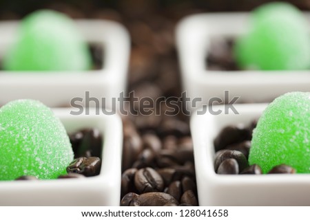 A jelly candy in a white bowl surrounded by coffee beans
