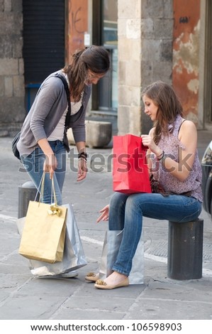 Two Girls While They Speak after to Have Made a Shopping