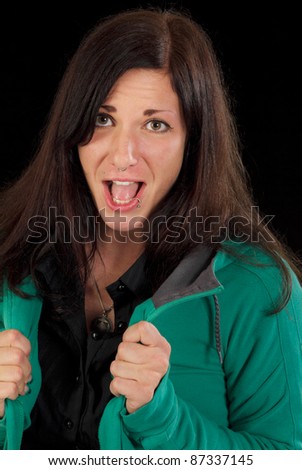 Excited screaming woman. Studio shot against a black background.